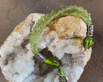 Artisan Bracelet - 7 1/4” Featuring 3 strands of Peridot & Lamp-work Beads with Silvertone Bali style Accent Beads and Charm Drop