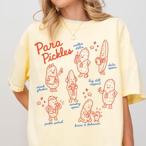 Camiseta divertida para auxiliares docentes, camiseta de actividades paranormales con diseño de pepinillo, camiseta de regreso a clases con colores cómodos para el equipo de auxiliares docentes, regalo de camiseta para auxiliares docentes