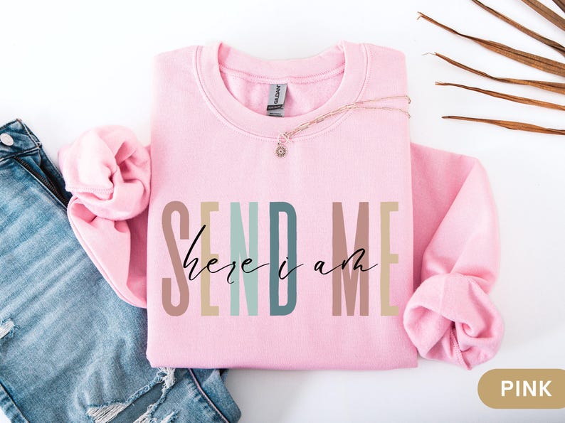 May include: Pink sweatshirt with the text "SEND ME here i am" in colorful letters.