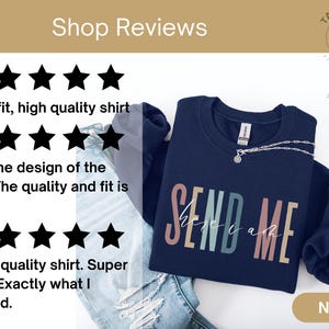 May include: Navy blue sweatshirt with the text "SEND ME" in rainbow colors. The sweatshirt is laid out on a light blue denim background with a gold tag that says "NAVY".