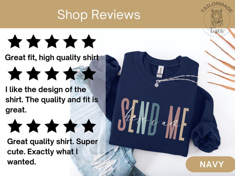 May include: Navy blue sweatshirt with the text "SEND ME" in rainbow colors. The sweatshirt is laid out on a light blue denim background with a gold tag that says "NAVY".