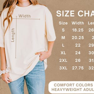 May include: Cream-coloured heavyweight adult tee shirt with a size chart. The chart lists sizes S through 3XL, with width measurements from 46.35 to 70.49 cm and lengths from 67.62 to 82.55 cm. The shirt is labeled "Comfort Colors 1717".