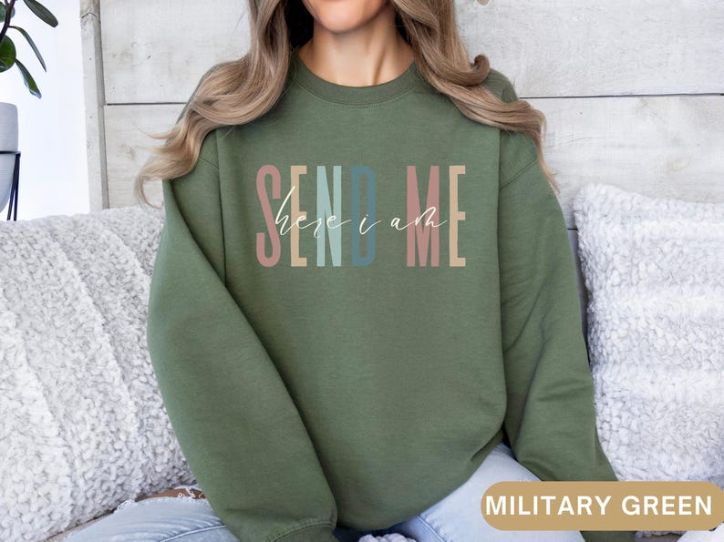 May include: A green sweatshirt with the text "SEND ME here i am" in colorful letters.