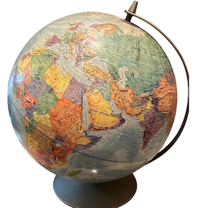 May include: A vintage globe with a light blue ocean and colorful continents. The globe is mounted on a gray base with a metal meridian and axis. The globe shows the political boundaries of countries.