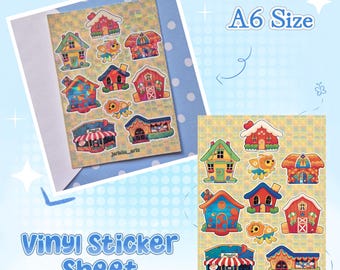 May include: An A6 size vinyl sticker sheet featuring various colorful illustrations of houses, buildings, and small animal characters. The stickers are arranged on a yellow and green checkered background with the text jericho_artz at the bottom.