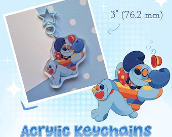 May include: A light blue acrylic keychain featuring a cartoon dog character with dark blue ears, orange eyes, and a red and yellow patterned scarf. The keychain has a star-shaped clasp and measures 3 inches in height. The text reads Acrylic Keychains.