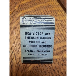 May include: A blue and white matchbook advertising guaranteed service for RCA-Victor and Emerson radios, Victor and Bluebird records, and special equipment built to order.