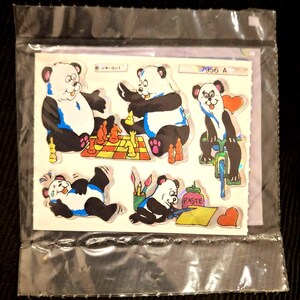 May include: A sheet of stickers featuring cartoon pandas in various poses. One panda plays chess, another rides a bicycle, and others are engaged in creative activities. The stickers are in a clear plastic sleeve.