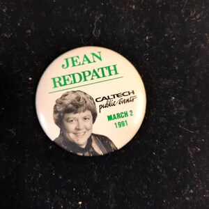 May include: A white button with green text that reads "JEAN REDPATH CALTECH public events MARCH 2 1991". A black and white photo of a woman with short hair is in the centre of the button.