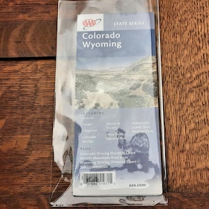 May include: A AAA State Series map for Colorado and Wyoming, featuring a landscape image. The map includes insets of Casper, Cheyenne, Colorado Springs, Denver & Vicinity, Mesa Verde National Park, and Yellowstone/Grand Teton National Parks.