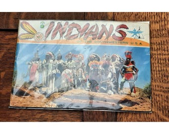 May include: A vintage postcard depicting a group of Native American people wearing traditional clothing. The postcard reads "Indians of the Southwestern U.S.A."