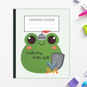 May include: Composition notebook with a green frog illustration wearing a knight's helmet and holding a shield and crossed swords. The text reads "Another Day... Another SLAY". School supplies surround the notebook.