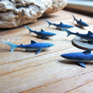 Tiny Blue Shark miniature animal mini-figures for crafts, dollhouses, terrarium supplies, fairy garden minis, dioramas, resin projects, soap slime filler, party favors, shark week parties, counting games, game pieces, scavenger hunts, jewelry making.