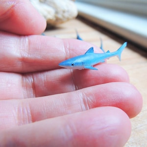 Tiny Blue Shark miniature animal mini-figures for crafts, dollhouses, terrarium supplies, fairy garden minis, dioramas, resin projects, soap slime filler, party favors, shark week parties, counting games, game pieces, scavenger hunts, jewelry making.