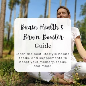 May include: A woman sits in a forest with her eyes closed, meditating. A white sign in front of her reads "Brain Health & Brain Booster Guide. Learn the best lifestyle habits, foods, and supplements to boost your memory, focus, and mood." The sign also includes the text "Nutravie Academy".