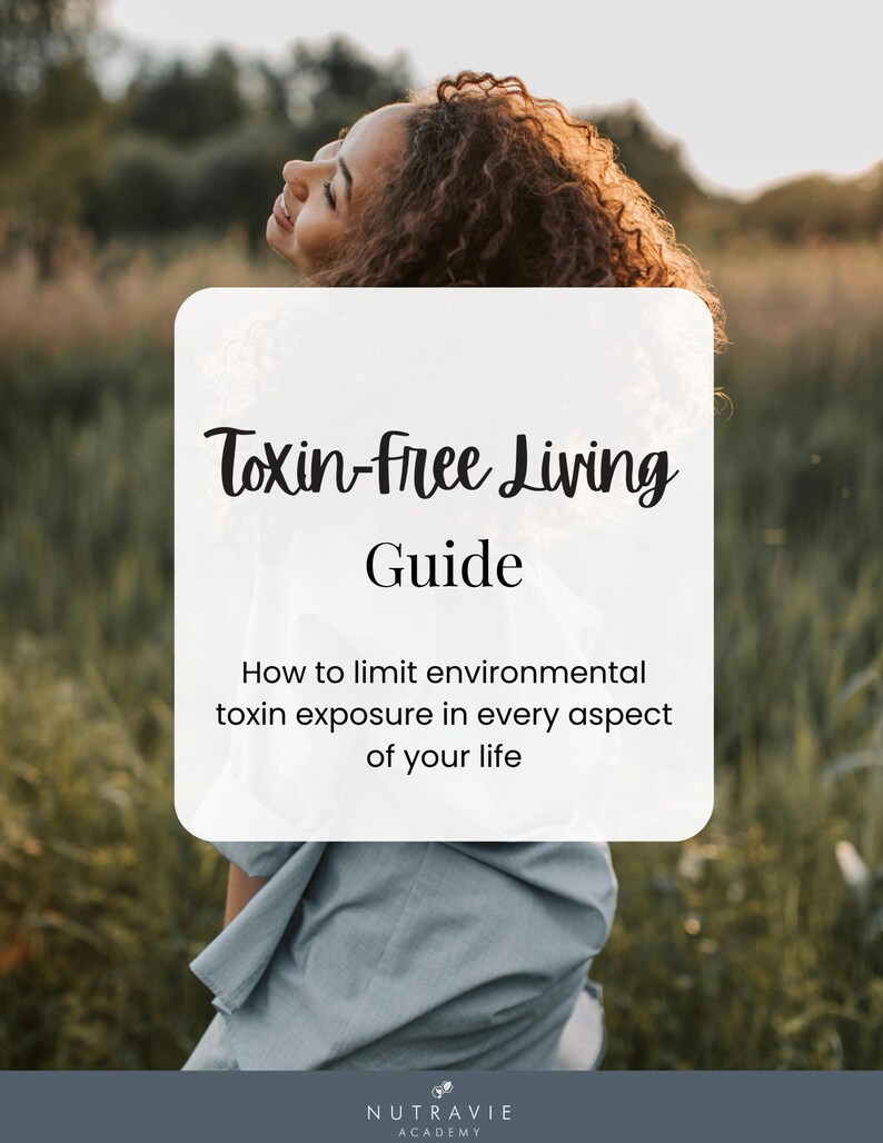 May include: A woman with curly brown hair stands in a field of tall grass. A white card with the text "Toxin-Free Living Guide" and "How to limit environmental toxin exposure in every aspect of your life" is in front of her. The card also has the text "Nutravie Academy" at the bottom.