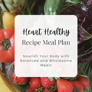 May include: A white card with the text "Heart Healthy Recipe Meal Plan" and "Nourish Your Body with Balanced and Wholesome Meals". The card is placed on top of a variety of fresh produce, including artichokes, courgettes, tomatoes, strawberries, bananas, and leafy greens.