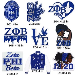 May include: A collection of nine blue and white embroidered patches featuring Zeta Phi Beta sorority symbols, including crests, hand signs, doves, a varsity jacket, and portraits, with labels indicating sizes from 3 inches to 4.35 inches.