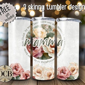 May include: Three skinny tumbler designs with floral and text details. One tumbler features the word "Mamma" surrounded by flowers. The other two tumblers have floral designs and text. The tumblers are white with silver lids.