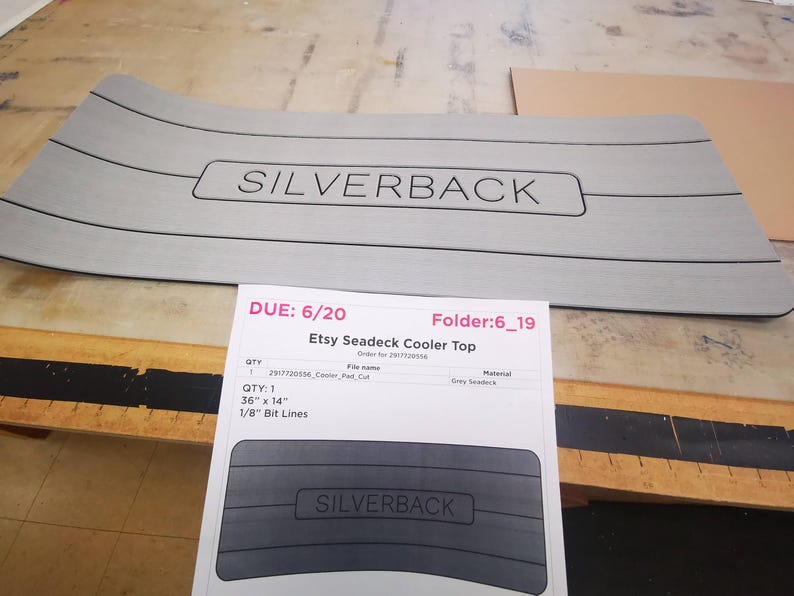 May include: A gray seadeck cooler top with the text "SILVERBACK" printed on it. The cooler top is 36 inches by 14 inches and has 1/8 inch bit lines.