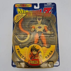 May include: A Dragon Ball Z Frieza II action figure in original blister packaging. The figure is yellow and orange with a long tail. The packaging features the text Dragon Ball Z, Frieza Saga, and Frieza II, along with a graphic of Goku.
