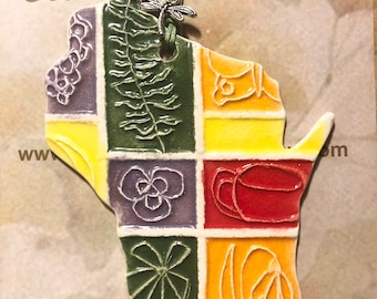 One of a Kind Ornament! Wisconsin state shaped ornament features a one of a kind design. Handmade ceramic! Arrives neatly gift bagged!