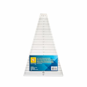 May include: A clear, triangular quilting ruler with black markings and measurements in inches. The ruler has a label with the text "FAT CATS TRIANGLE RULER" and is designed for creating triangle shapes in quilting projects. The ruler measures up to 12 inches.
