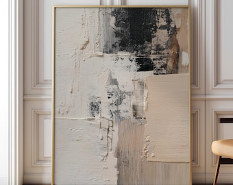 May include: Abstract textured art piece in a gold frame. The artwork features a palette of white, black, and beige tones, with visible brushstrokes creating a layered effect. The piece is leaning against a white wall.