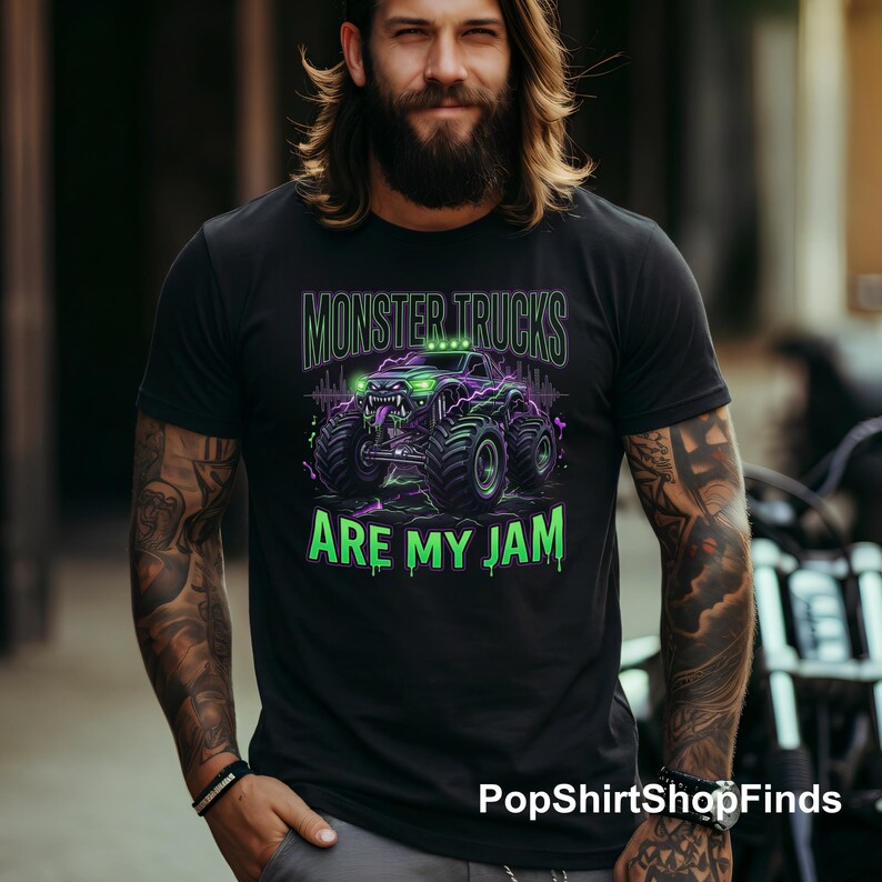 Pu&ograve; includere: T-shirt nero con grafica di monster truck verde neon e viola. Il testo "MONSTER TRUCKS ARE MY JAM" &egrave; sopra e sotto il disegno del camion. La maglietta &egrave; realizzata in un materiale morbido.