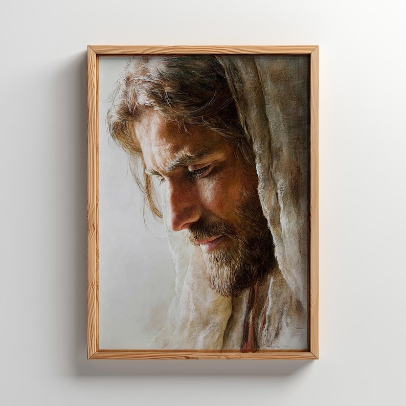 May include: A framed portrait of a man with long hair and a beard, looking down with a contemplative expression. The artwork is in warm tones, with a focus on the man's face and the details of his features. The frame is made of light-colored wood.