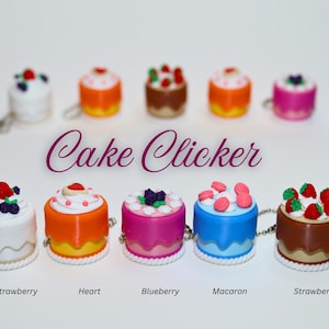 May include: A collection of miniature cake-shaped clickers in various colors, each topped with different decorative elements like strawberries, blueberries, and macarons. The text "Cake Clicker" is displayed above the cakes.