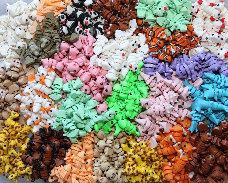 May include: A large collection of colorful, small, articulated plastic animal figurines. The animals include giraffes, pandas, fish, and more.
