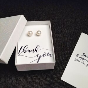 May include: A small white box with a thank you message and two pearl earrings inside. A separate card says "Jennifer, I appreciate all you do for me."