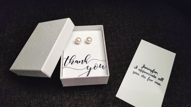 May include: A small white box with a thank you message and two pearl earrings inside. A separate card says "Jennifer, I appreciate all you do for me."