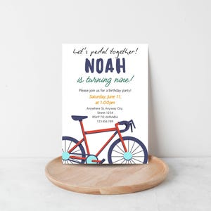 May include: A white invitation card with the text "Let's pedal together!" and "NOAH is turning nine!" in blue. A red bicycle illustration is at the bottom. The invitation includes party details: date, time, and RSVP information.