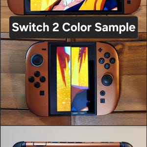 以下が含まれることがあります： 銅色のNintendo Switchコンソール。黒いアクセントがあり、画面にはビデオゲームのキャラクターが表示されています。「Switch 2 Color Sample」というテキストが黒いバーに表示されています。コンソールは複数の角度から表示されています。