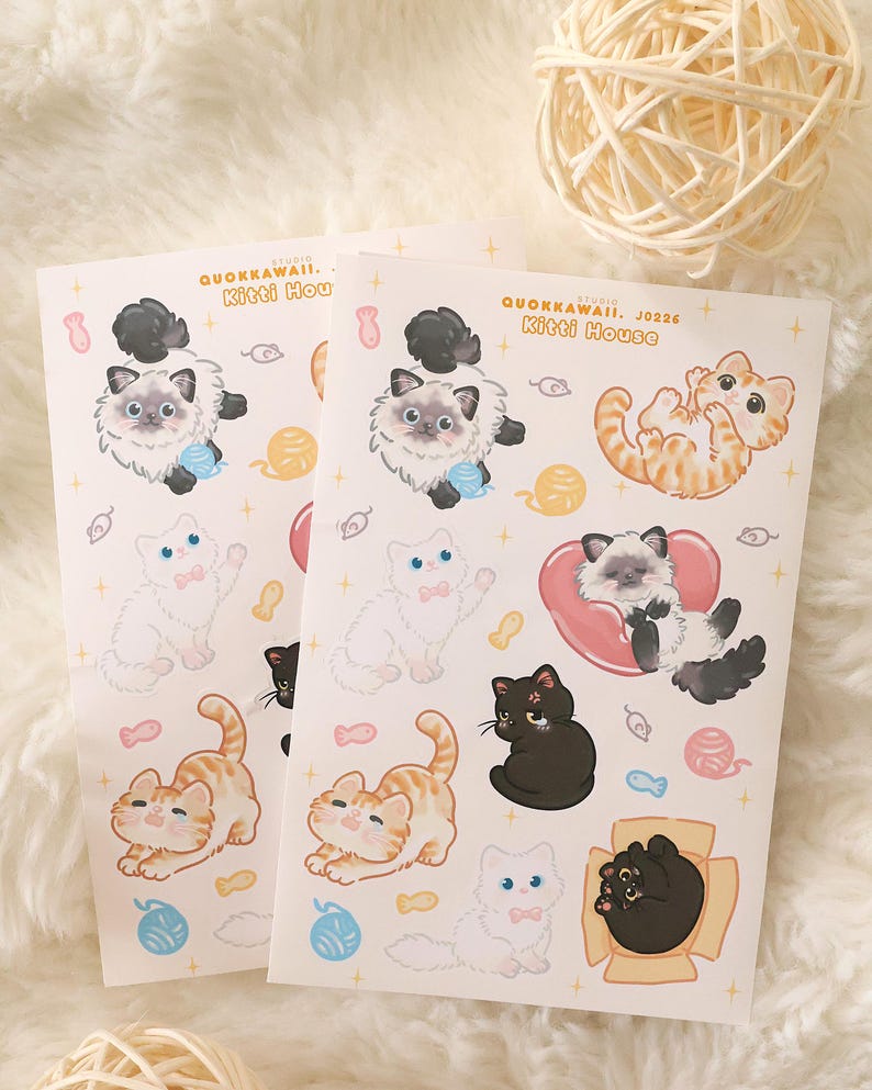 May include: Two sheets of stickers featuring various cartoon cat illustrations. The stickers include cats in different poses, colors, and patterns, with some holding yarn balls or wearing bows. The text "QUOKKAWAII. Kitti House" is printed on the stickers.