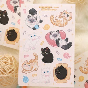 May include: Sheets of stickers featuring various cartoon cats in playful poses. The stickers include cats in boxes, with yarn balls, and hearts. The text "QUOKKAWAII. J0226 Kitti House" is printed on the sheet.