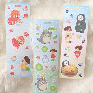 May include: Three sticker sheets with characters from animated films. The stickers feature characters from "Ponyo", "My Neighbour Totoro", and "Spirited Away". The stickers are colourful and feature various characters and objects from the films.