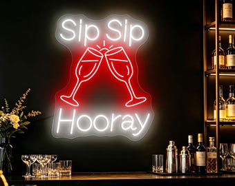 May include: A neon sign featuring the white text "Sip Sip" above a red graphic of two clinking champagne glasses, with the white text "Hooray" below. The sign is mounted on a dark wall, emitting a bright glow that illuminates the surrounding area.