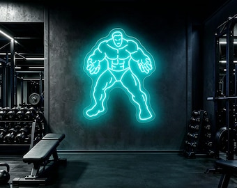 May include: A bright cyan neon sign mounted on a dark wall, depicting the outline of a muscular, broad-shouldered figure in a powerful stance with arms slightly bent and hands open, creating a glowing silhouette against the dim gym environment.