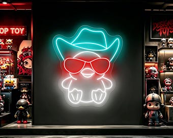 May include: A neon sign featuring a white outline of a small duckling wearing a teal cowboy hat and red sunglasses. The sign is mounted on a dark wall in a retail space filled with various collectible toy figures on display shelves.