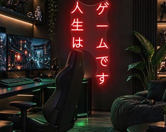 May include: A red neon sign mounted on a dark wall featuring the Japanese text "人生はゲームです" which translates to "Life is a game." The sign has an irregular, organic shape and emits a bright, glowing red light in a room.