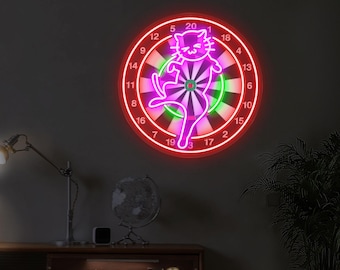 May include: A neon dartboard with a red outer ring, a green and white center, and a pink cat silhouette. The numbers 1-20 are visible around the board. The dartboard is mounted on a dark gray wall.