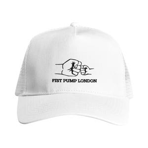 May include: White trucker hat with a mesh back and a curved brim. The front of the hat features a black graphic of two fists bumping, with the text "FIST PUMP LONDON" below the graphic.