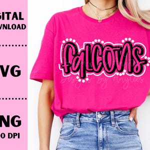 May include: A pink t-shirt with the word "Falcons" in black and white lettering with white polka dots around the word.