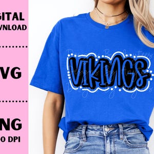 May include: A blue t-shirt with the word "VIKINGS" in black and white lettering. The lettering is outlined in white and has white dots around it.