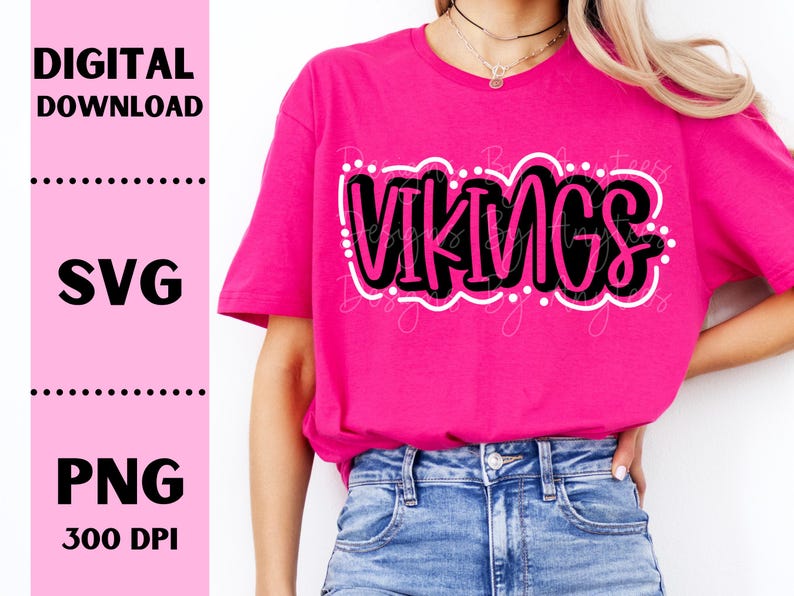 May include: A pink t-shirt with the word "VIKINGS" in black and white lettering. The lettering is in a bold, playful font and is surrounded by white dots.
