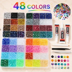 May include: A craft kit featuring four clear plastic organizers filled with small round rhinestones in 48 colors, two tubes of B-7000 adhesive, a white wax pencil, and two pairs of metal tweezers. The text 48 COLORS is printed at the top.