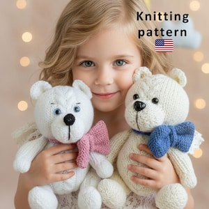 May include: A young girl holds two white knitted teddy bears, each with a bow tie. One bear has a pink bow, the other a blue bow. The image includes the text "Knitting pattern" with an American flag.